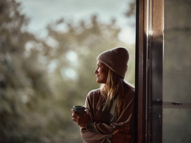 istock Smiling woman day dreaming while enjoying in her coffee time. 1483808094