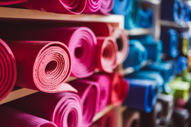 istock Pink yoga mats rolled up on shelves in the studio 1483809804