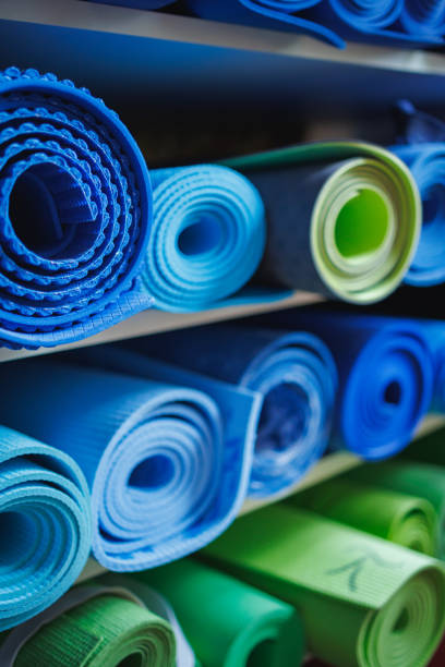 istock Blue and green exercise mats rolled up on shelves in the studio 1483809807