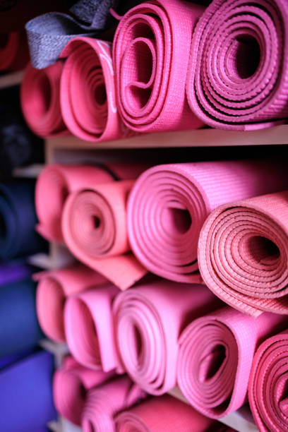 istock Pink exercise mats rolled up on shelves in the studio 1483809819