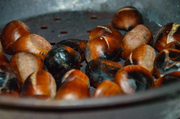 istock Chestnuts in the holed pan over the embers 1483809861