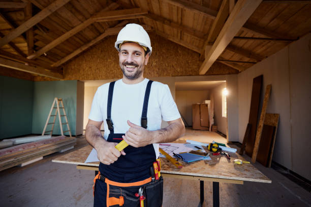 istock Happy manual worker standing at construction site during home renovation. 1483810048