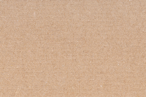 Beige cardboard texture with blank space for text. Light abstract template as background.