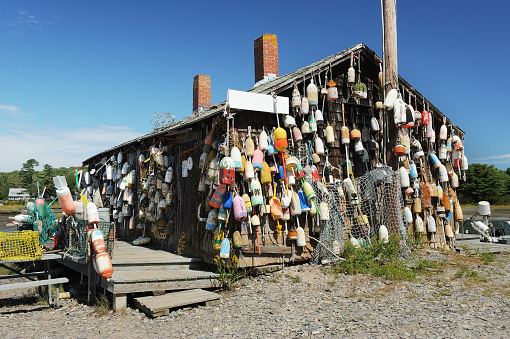 Fishing shed or shack covered with old colorful fishing buoys, Cape Neddick, Maine, USA