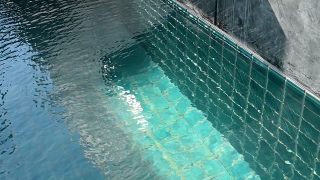 water wave slow motion of swimming pool on cement wall, construction industry