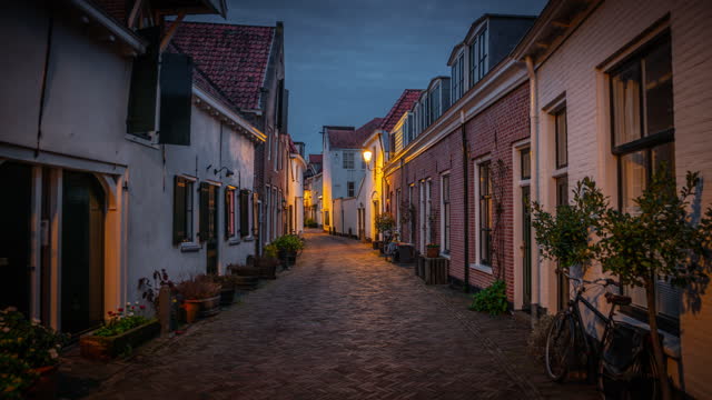 Illuminated old town street in Amersfoort at dusk - Netherlands
