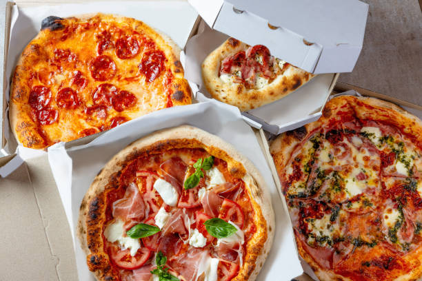 istock Various types of pizza in open delivery boxes 1483818190