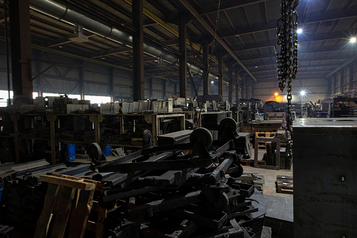 The metalworking shop of a factory in developing countries is dark and dirty.