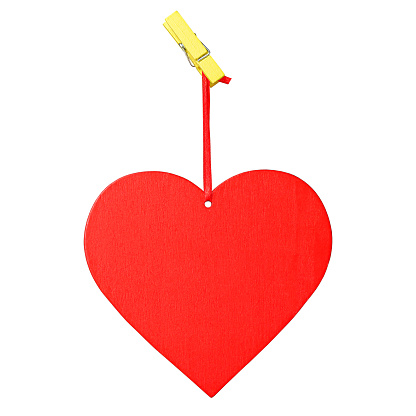 Red wooden heart on a red ribbon with yellow wooden clothespin isolated on white background. Love concept