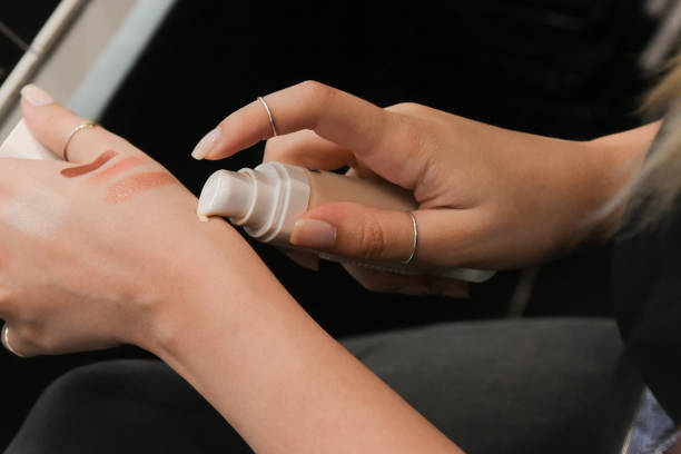 istock A young girl student testing, applying a foundation on her hands in a perfumery. A businesswoman is testing the powder's tone and nuance by putting it on her arm. Selecting a make-up. 1483821349