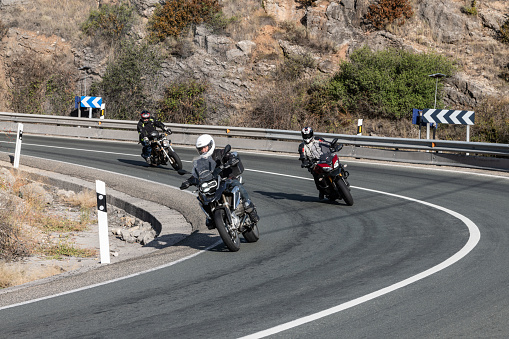 Riding the classic motorcycle through the countryside in Navarre, Spain.