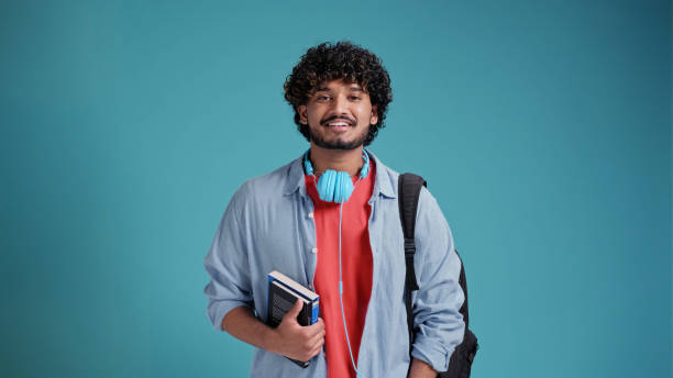 istock indian male student portrait on blue background 1483826098