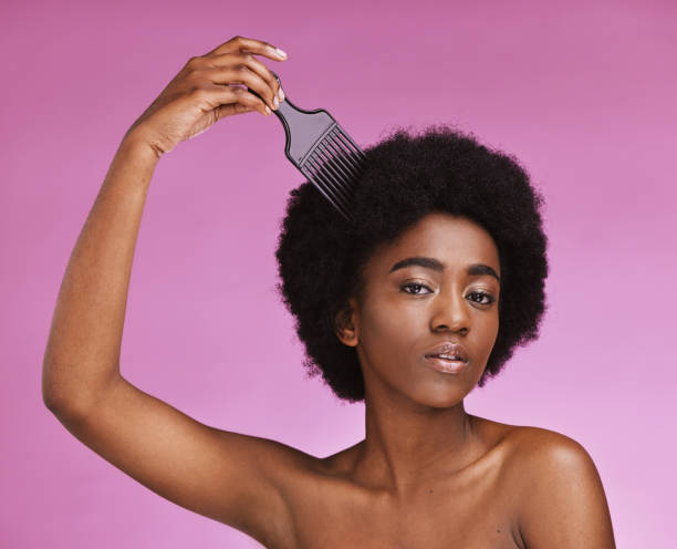 istock Portrait, hairstyle or afro brush on beauty studio background in relax grooming routine, texture maintenance or growth wellness. Black woman, comb or natural hair and skincare makeup on isolated pink 1483829292