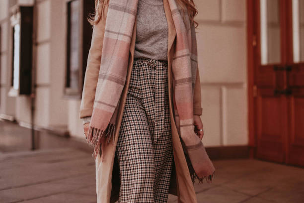 istock Beige long autumn warm coat, checkered pants and scarf. 1483830281
