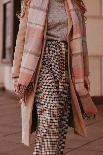 istock Beige long autumn warm coat, checkered pants and scarf. 1483830369