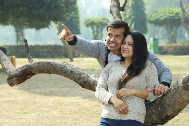 istock Beautiful Indian happy couple standing besides a tree having a romantic time. 1483832153