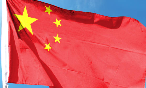 istock Chinese flag on cloudy sky. waving in the sky 1483834069