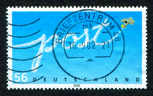 Germany stamp: Air mail -  Airplane flying in the sky