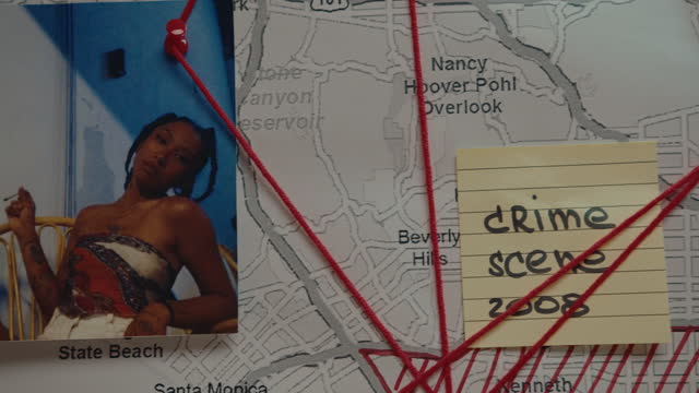 Pinboard with Photo, Map and Sticky Note Linked with Red Thread