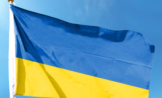 istock Ukrainian flag on cloudy sky. waving in the sky 1483838911