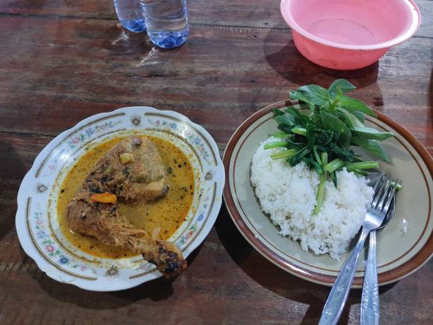 istock Ayam pedas or Spicy Chicken Curry with rice and lalapan 1483839687