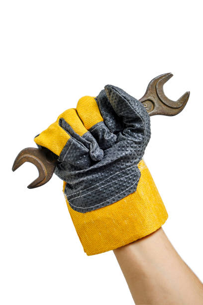 istock Builder gloved hand holding wrenches white background.Concept for Labor Day first May. 1483839931