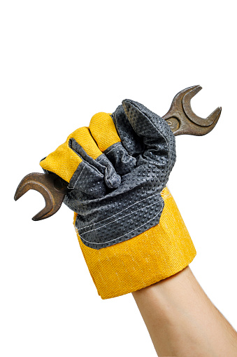 Builder gloved hand holding wrenches white background.Concept for Labor Day first May