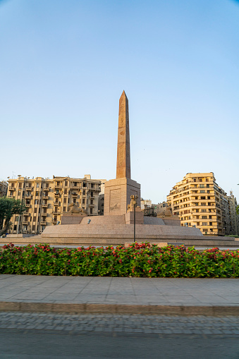 wide view of the obelisk in the center garden of the historical square in Cairo Downtown