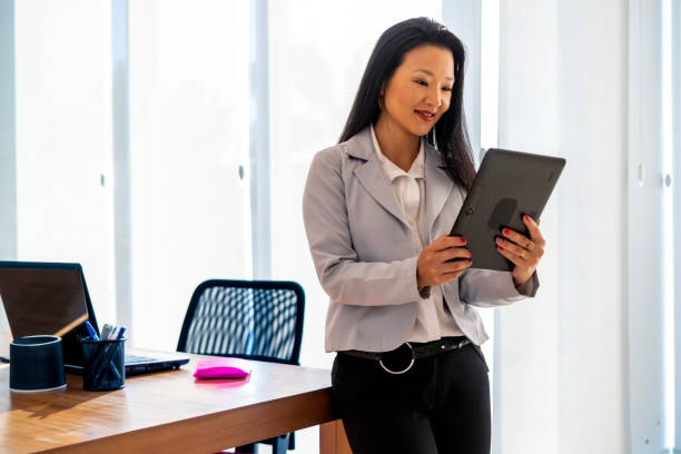 istock Japanese woman in a office using a digital tablet 1483842624