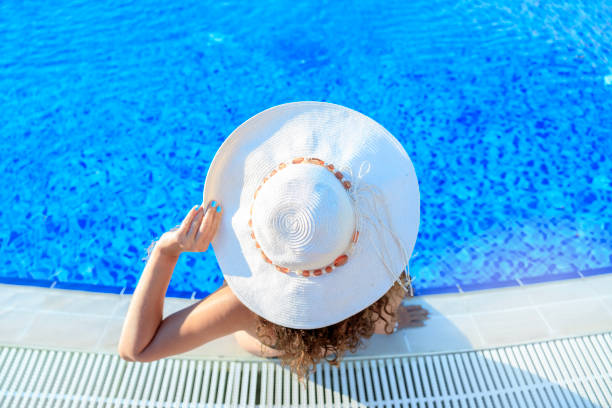 istock Woman relaxing in a resort swimming pool 1483844414