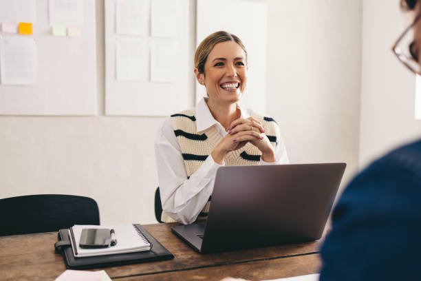 istock Happy hiring manager interviewing a job candidate in her office 1483844804
