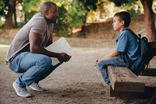 istock School teacher motivating a troubled school kid outside class 1483845919