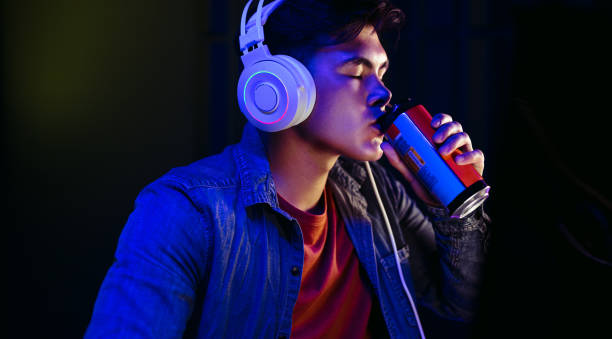 istock Computer gamer drinking an energy drink and taking a break from gaming at night 1483846109