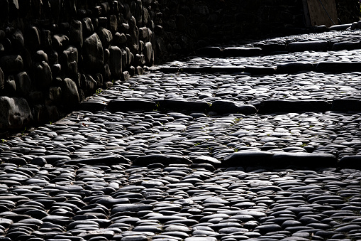Quaint cobbled steps in the village of Clovelly Devon back-lit making an abstract pattern