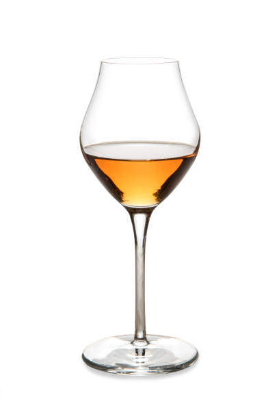 Amber sweet wine in tulip glass Amber sweet wine or italian wine passito in glass isolated on white with clipping path included sherry stock pictures, royalty-free photos & images