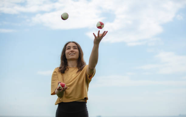 istock Juggler young woman with blue sky. 1483851570