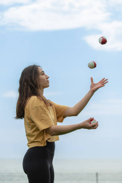 istock Juggler young woman with blue sky. 1483851697