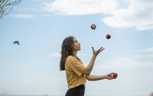 istock Juggler young woman with blue sky. 1483851698