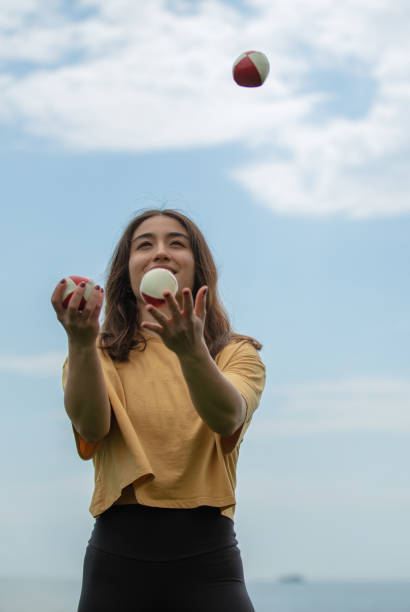 istock Juggler young woman with blue sky. 1483851953