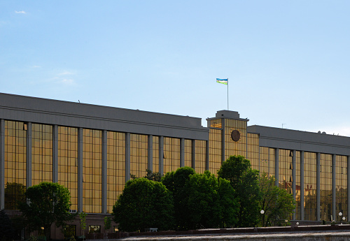 Tashkent, Uzbekistan: Government headquarters, Cabinet of Ministers, golden glass façade and Uzbek flag - prime minister office.