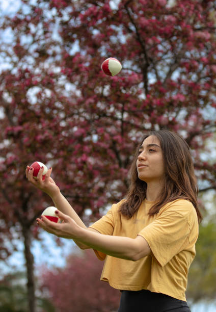 istock Juggler young woman in public park. 1483852735