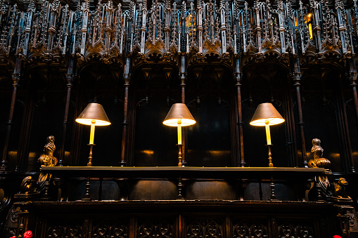 Inside the Quire (choir) in Manchester Cathedral. Showing Misericord and table lamps