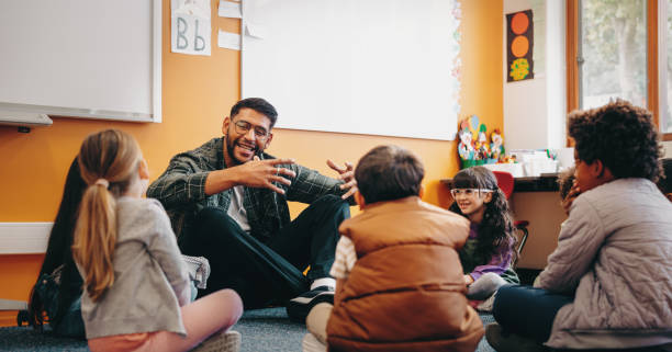 istock Male educator talking to his students in a classroom. Man teaching elementary school children 1483855399
