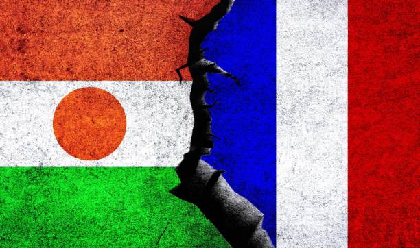 Niger France relations. France and Niger flag together France vs Niger flags on a wall with crack. Niger France relations. France Niger conflict, war crisis, economy, relationship, trade concept niger stock illustrations