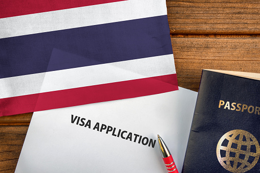 Visa application form, passport and flag of Thailand