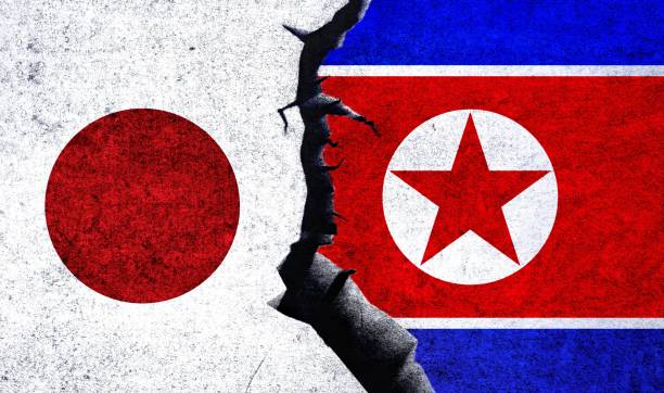 istock Japan vs North Korea flags on a wall with crack. Japan North Korea conflict. 1483857646