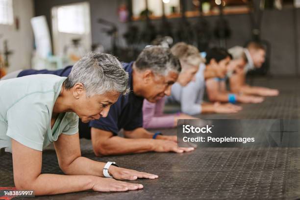 People Fitness And Plank In Class At Gym For Workout Core Exercise Or Training Together Indoors Diverse Group Or Team In Warm Up Ab Muscle Session For Sport Health Or Wellness On Gymnasium Floor Stock Photo - Download Image Now