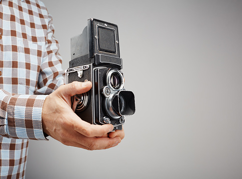 Taking a picture with a vintage twin lens reflex (TLR) medium format camera with waist level finder