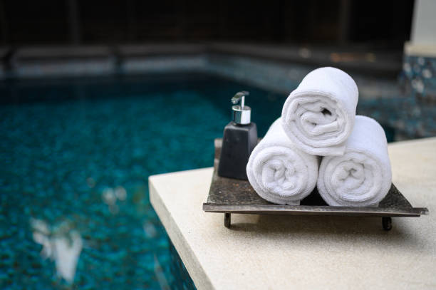 istock Concept Spa : Spa set Towels with bottle cream pump Placed by the pool 1483862209
