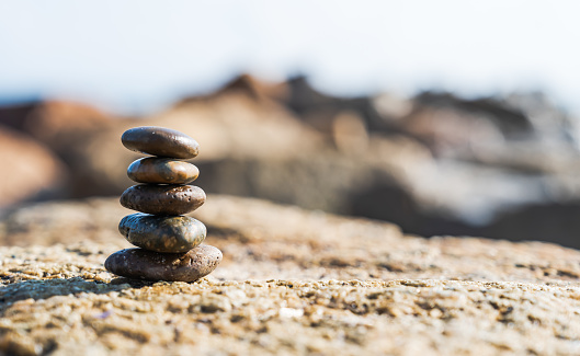 Rock stone stack balance on sea beach backgrounds, sign Zen meditation and peaceful